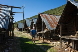 Hiking Lycian way. Man is trekking next to Traditional wooden depots in Bezirgan highlands on Lycian Way trail, Outdoor activity in Turkey