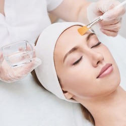 Cosmetology beauty procedure. Young woman skin care. Beautiful female person. Rejuvenation treatment. Facial chemical peel therapy. Clinical healthcare. Doctor hand. Dermatology cleanser.
