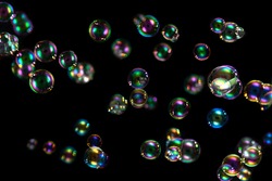 Soap bubbles  with rainbow colors  isolated on black background.colorful foam soap bubbles.