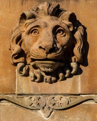Close-up of a Lion head sculpture on the base of the Sir Walter Scott Monument in George Square, in the city of Glasgow, Scotland, UK.