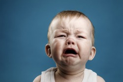 Photo of nine month baby crying, isolated