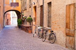 old small stone medieval street in historical center of Ferrara, Italy