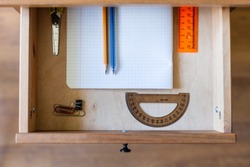 above view of stationery set in open drawer of nightstand