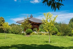 national Korean architecture - a pagoda with a bell in the middle of the park, in traditional Korean 
