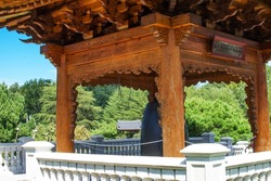 national Korean architecture - a pagoda with a bell of peace in the middle of a traditional Korean style batan garden.