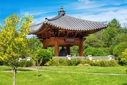 national Korean architecture - a pagoda with a bell in the middle of the park, in traditional Korean style. wabi sabi style