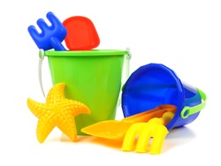 Toy sand pails and shovels over a white background