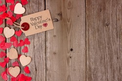 Happy Valentines Day gift tag with scattered wooden hearts and confetti side border on a rustic wood background