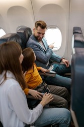 Parents and daughter traveling together on airplane