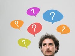 thinking man with many question marks in bubbles above his head, against grey background