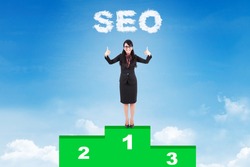 Happy businesswoman with SEO strategy standing on podium