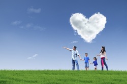 Happy family walking in the park with cloud of love in the sky