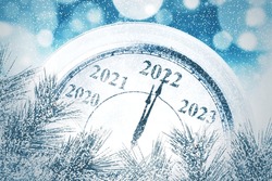 Close up of classic clock counting last moments before Christmas and New Year 2022 event with blurred sparkling lights background