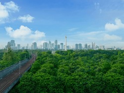 Beautiful aerial view of green city forest near National Monument Monas in Jakarta shot in the morning