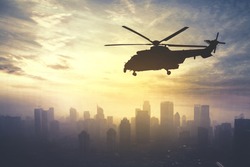 Picture of army helicopter flying over downtown, shot at sunrise time