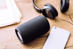Black mini wireless portable bluetooth speaker for music listening. 