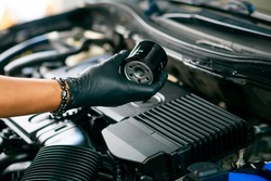Technician change car oil filter, automotive spare part. Car maintenance concept.