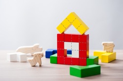 colorful wooden puzzle blocks toy and wooden animals, wooden construction blocks with geometric shapes.