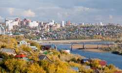 Ufa city at the autumn. You can see Belaya (White) river and modern district behind the bridge.