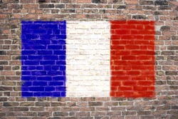 French flag sprayed on brick wall