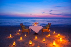  glass of wine And equipment on a wooden table with seascape and skyline in the evening with sunset tone style,Sunset is a romantic candlelight.