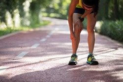 Female runner suffering with pain on sports running knee injury 