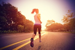 Runner athlete running on road. woman fitness sunrise jogging  workout wellness concept. 