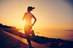 Runner athlete running at seaside. woman fitness silhouette sunrise jogging workout wellness concept. 