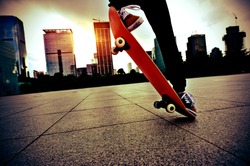 skateboarder legs skateboarding trick ollie  at city skate park