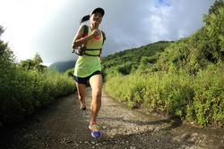 young fitness woman trail runner running on seaside mountain 