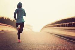young fitness woman runner athlete running at road