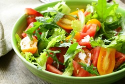 fresh healthy salad with tomatoes and arugula