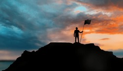 business, success, leadership, achievement and people concept - silhouette of businessman with flag on mountain top over sunset background
