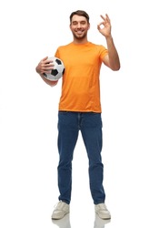 sport, leisure games and people concept - happy smiling man or football fan with soccer ball showing ok hand sign over white background