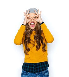 people, style and fashion concept - happy young woman or teen girl in casual clothes and hipster hat having fun