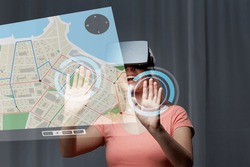 technology, virtual reality, cyberspace, entertainment and people concept - happy young woman with virtual reality headset or 3d glasses at home looking at gps navigator map projection
