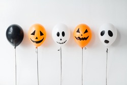 holidays, decoration and party concept - scary air balloons for halloween over white background