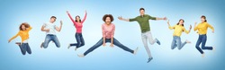 happiness, freedom, motion and people concept - smiling young international friends jumping in air over blue background