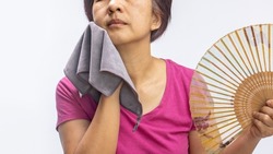 Middle aged woman feel hot flashes or overheated , symptoms of menopause