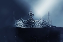 mysterious and magical photo of of beautiful queen/king crown over gothic snowy dark background. Medieval period concept