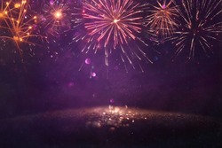 abstract gold, gold and purple glitter background with fireworks. christmas eve, 4th of july holiday concept