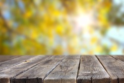 wood planks and out of focus background with sun flare. room for product display.