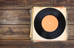 top view of records stack over wooden table