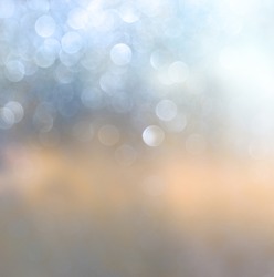 abstract photo of glitter lights background. gold, silver, and white colors . de-focused. 