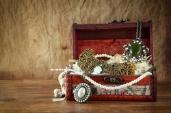 A collection of vintage jewelry in antique wooden box