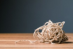 Tangled jute rope on the table, concept for complicated or complex issue, mind and mental problem (psychotherapy)