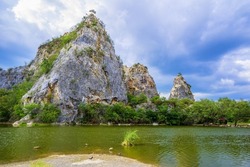 Limestone mountain and lake view at Mountain Snake Stone Park, or Khao Ngu Stone Park, tourist attraction in Ratchaburi province, Thailand
