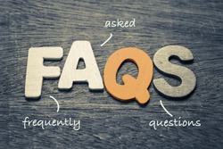 FAQs ( frequently asked questions ) wood letters on wood background