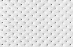 White dotted quilted leather soft background pattern or texture