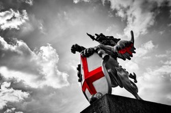 St George dragon statue in London, the UK. Symbol of England. Black and white with red St. George's Cross